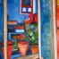Colorful still life with flowers in pots, visible through an open window front, in the expressive painting style of Nikolaus Kriese, who offers creative commissioned paintings.