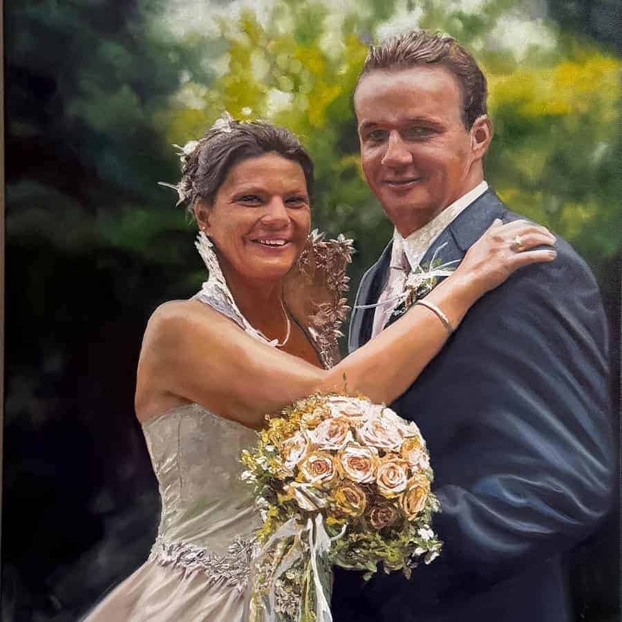 Glückliches Hochzeitspaar bei der Feier, umgeben von Natur, mit Braut in weißem Kleid und Bräutigam in Anzug, beide lächelnd und in liebevoller Umarmung.